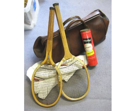 LEATHER HOLDALL, early 20th century containing two wooden tennis racquets circa 1900, a tube containing vintage Dunlop tennis