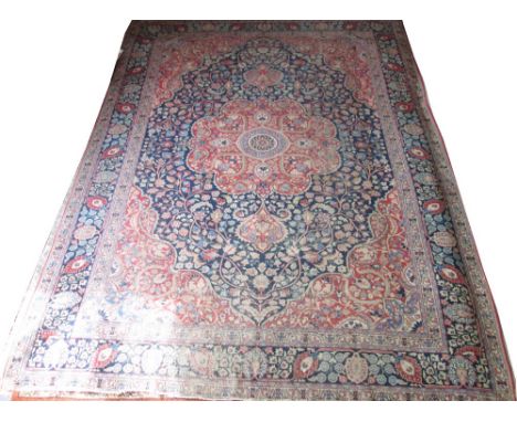 ANTIQUE PERSIAN TABRIZ CARPET, 350cm x 258cm, central medallion on a sapphire field with rouge spandrels within a correspondi