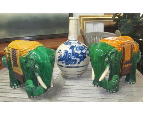 JARDINIERE STANDS, two similar, in the form of elephants in green glazed ceramic, 36cm H x 52cm W x 22cm D, and a blue and wh