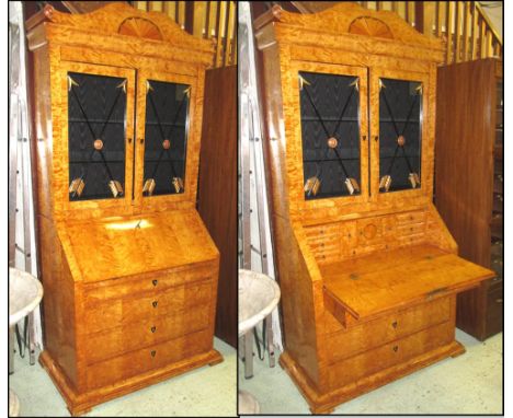 BUREAU BOOKCASE, Biedermeier style, satinbirch the shaped inlaid surmount over a pair of glazed doors with gilt arrow applied