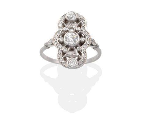 An Art Deco Diamond Plaque Ring, a central grain set old cut diamond within a single-cut diamond set pierced and lobed frame,