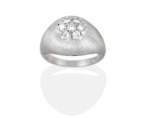 A Diamond Cluster Ring, seven round brilliant cut diamonds inset to a brushed polished tapering shank, total estimated diamon