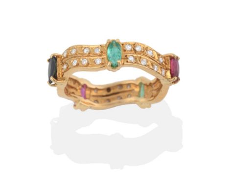 An Emerald, Ruby, Sapphire and Diamond Eternity Ring, marquise cut emeralds, rubies and sapphires spaced by two curved rows o