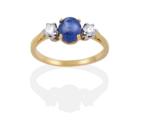 An 18 Carat Gold Star Sapphire and Diamond Three Stone Ring, an oval cut star sapphire spaced by round brilliant cut diamonds