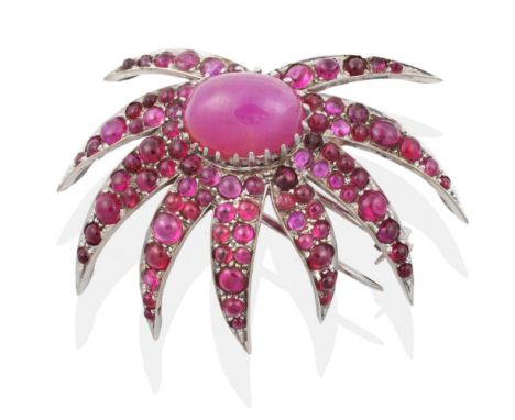 A Ruby Spray Brooch, an oval cabochon ruby in a claw setting within a border of cabochon ruby set leaves, measures 3cm by 4.5