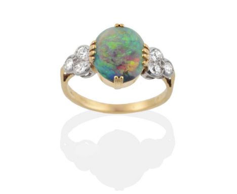 An 18 Carat Gold Early Twentieth Century Black Opal and Diamond Ring, an oval black opal in a fancy claw setting, to grain se