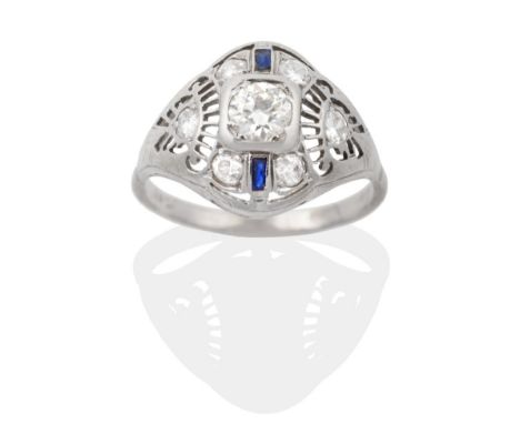 An Art Deco Sapphire and Diamond Cluster Ring, an old cut diamond within a tapering pierced frame set with two baguette cut s