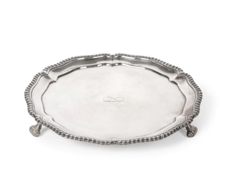 A William IV Silver Salver, Robert Garrard, London 1831, shaped circular with gadroon rim and on three scroll supports, the c