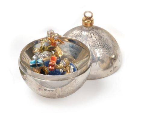 Stuart Devlin: A Parcel Gilt Silver Surprise Christmas Bauble, London 1983, the interior with a family group opening presents