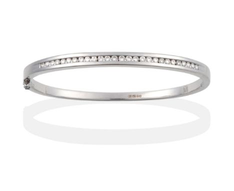 An 18 Carat White Gold Diamond Bangle, the front channel set with round brilliant cut diamonds to a plain hinged back, stated