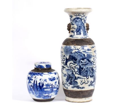 A CHINESE BLUE AND WHITE LARGE BALUSTER VASE, painted with temple dogs within bands of bronzed relief decoration, incised sea