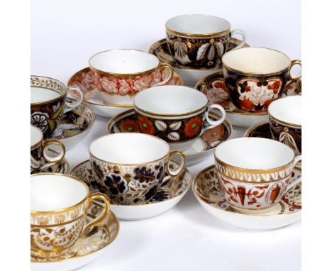A PAIR OF EARLY 19TH CENTURY DERBY TEA CUPS AND SAUCERS, with gilt heightened orange decoration, puce marks, and a collection