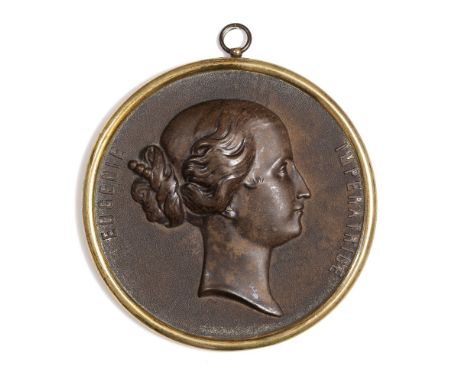 A 19TH CENTURY CIRCULAR BOIS DURCI PLAQUE, relief decorated with a portrait of Imperatrice Eugenie, 11.5cm