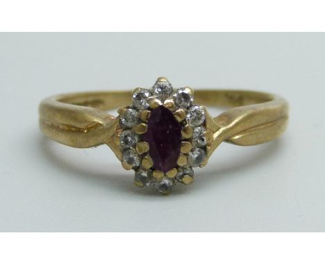 A 9ct gold ring set with a ruby and diamond cluster, 2.1g, K/L 