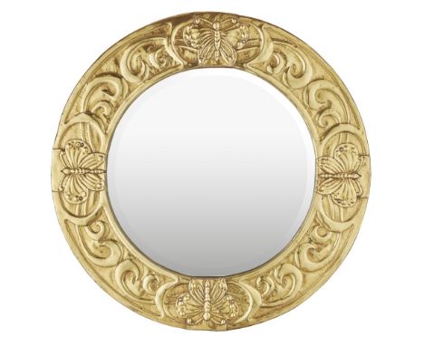 SCOTTISH SCHOOL  ARTS &amp; CRAFTS BRASS WALL MIRROR, CIRCA 1910   the circular bevelled plate enclosed by frame embossed wit