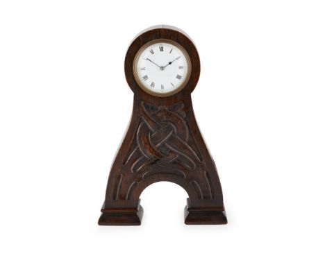 ARCHIBALD KNOX FOR LIBERTY &amp; CO., LONDON  ARTS &amp; CRAFTS OAK MANTEL CLOCK, CIRCA 1900  the single-train movement with 