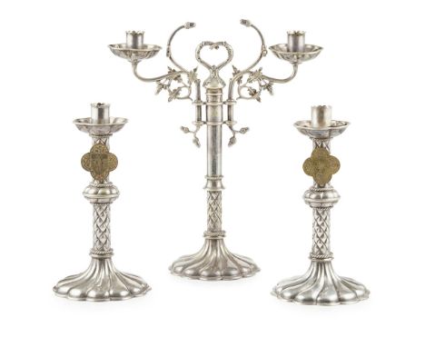 MANNER OF A.W.N. PUGIN FOR JOHN HARDMAN &amp; CO., BIRMINGHAM  GARNITURE OF THREE GOTHIC REVIVAL ALTAR CANDLESTICKS, CIRCA 18