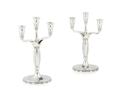 GEORG JENSEN (1866-1935)  PAIR OF DANISH STERLING SILVER THREE-LIGHT CANDELABRA, 1915-30   each raised on a circular base, th