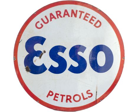 Motoring enamel advertising sign GUARANTEED ESSO PETROLS measuring 25.5in diameter. In good condition with a few chips.