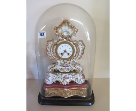 A 19th century floral decorated French porcelain mantel clock with silk suspension striking on a bell with pendulum and key u