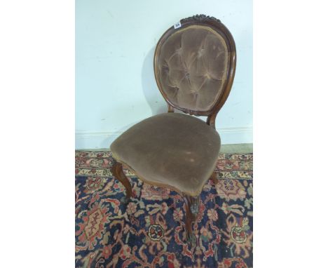 A Victorian carved walnut single button back side chair