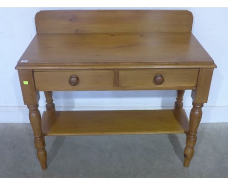 A Victorian stripped and waxed pine washstand with two drawers on turned legs united with under shelf - Width 100 cm 
Conditi