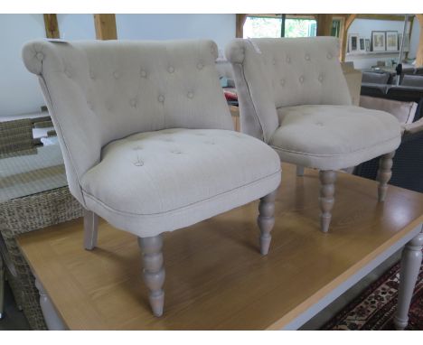 A pair of new button back bedroom chairs