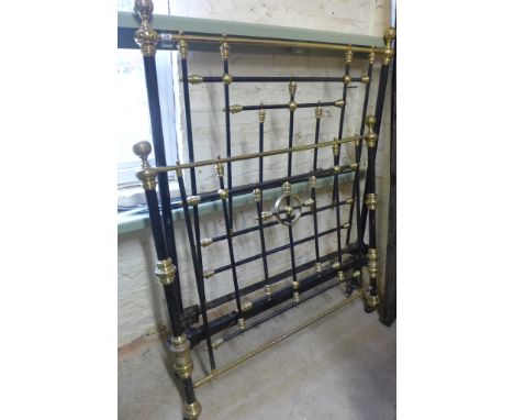A brass and iron 4ft bed with side rails - In well used condition, marks and areas of damage throughout