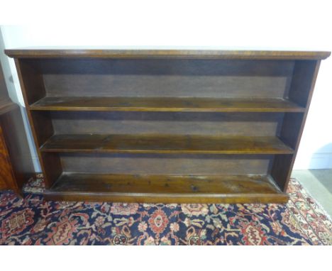 An oak fixed shelf bookcase 1.68m wide x 99cm tall x 25cm deep