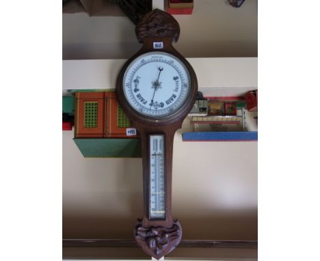 An English oak mounted wheel barometer with thermometer and applied decoration below - height 75cm x width 25cm x depth 7cm