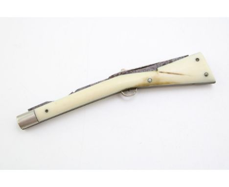 A novelty antique cigar piercer and fork in the form of a rifle, ivorine sides, Sheffield maker, 16cm long.