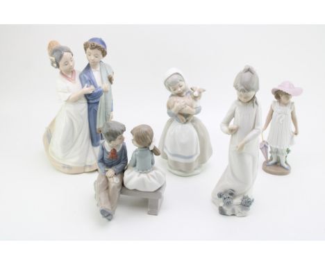 A collection of Nao figurines to include a couple, a girl with dog, a girl with an umbrella and others (5).  In good conditio