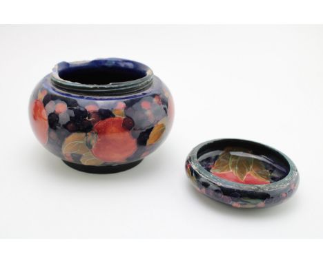 Two Moorcroft Pomegranate pattern items to include a bowl with an ashtray, both damaged with ribbed lips (two - af).