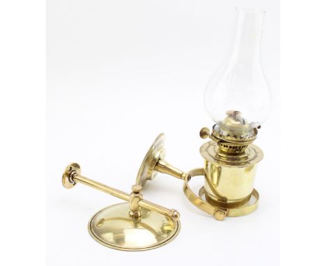 Brass ships wall mounted gimbal paraffin lantern by Nauticalia England, together with mountable reflection plate, 25cm tall.