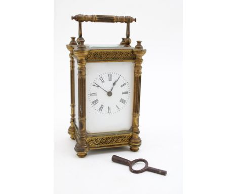 An early c20th decorative brass carriage clock with enamel dial c1900  the case is in excellent condition unpolished, some ch