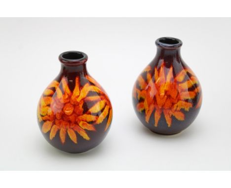 A pair of Poole Pottery bulbous vases with a sunburst design, 12.5cm tall (2).  In good condition with no obvious damage or r