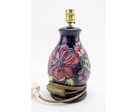 Moorcroft clematis lampbase on blue background, 27cm tall.  In good condition with no obvious damage or restoration.