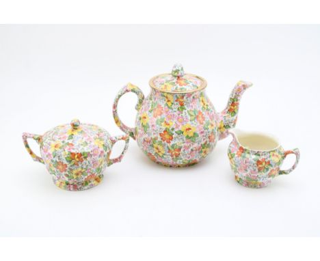 Art Deco period Wade Heath chintz pattern trio comprising of teapot, cream jug and lidded sugar bowl, 17.5cm tall. (3)  . Of 