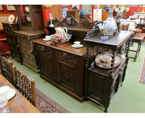 A Victorian carved oak serving cabinet the raised shelf back with green man decoration to drawers also over two door cupboard