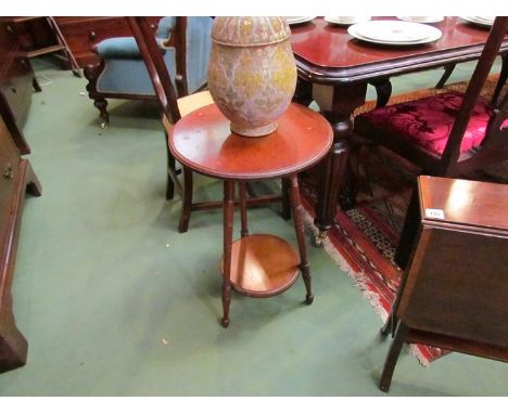 A James Shoolbred & Co mahogany two tier lamp table with ring turned legs, label verso, 40cm diameter 