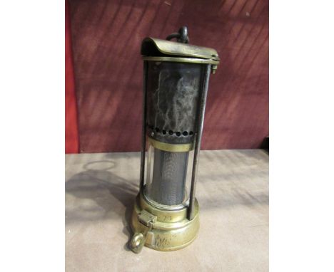 A miner's lamp by Donald Lloyd's patent, J.H Naylor Wigan tall glass and relatively short bonnet, 20cm tall 