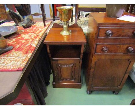 In The Manner of Jas Shoolbred, a late Victorian walnut Arts and Crafts bedside cabinet the carved raised back over an open s