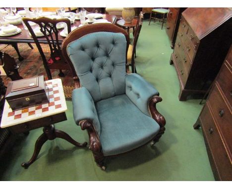 A circa 1840 mahogany armchair with button back rest over scroll carved arms the bow front seat over turned and fluted legs w