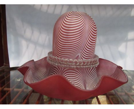 A Victorian Nailsea style glass night light, striated cranberry frilled base 