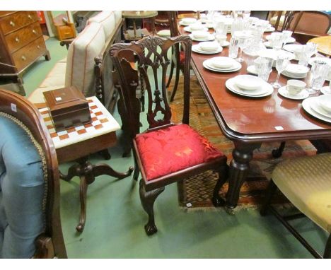 A set of four late Victorian mahogany Chippendale style dining chairs, foliate back crests, red seats, on ball and claw feet 