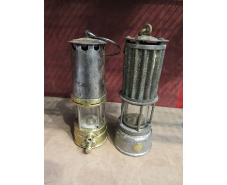 Two miner's lamps, one labelled "Premier Lamp & Engineering Co, Leeds" and with corrugated bonnet