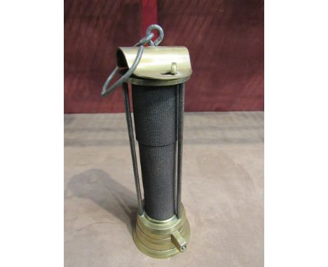 A Davy miner's lamp with flip top and flared base gauze protected by three rods, 23cm tall  