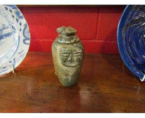 An approximately 3000 B.C. Neolithic guardian lidded vase with human alien face. Thought to originate from a culture which co