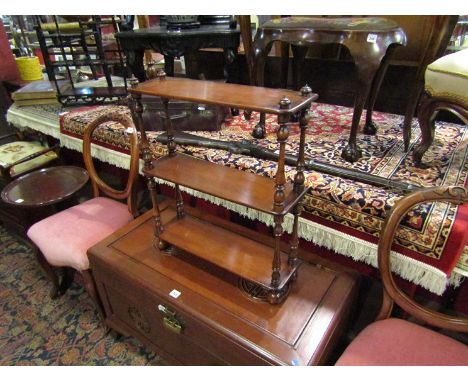 A Victorian mahogany wall hanging three tier diminutive wall shelf, the finial top on turned supports, bun feet