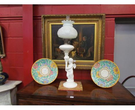 A Victorian oil lamp with opaque shade, ceramic cherub base, wing a/f 